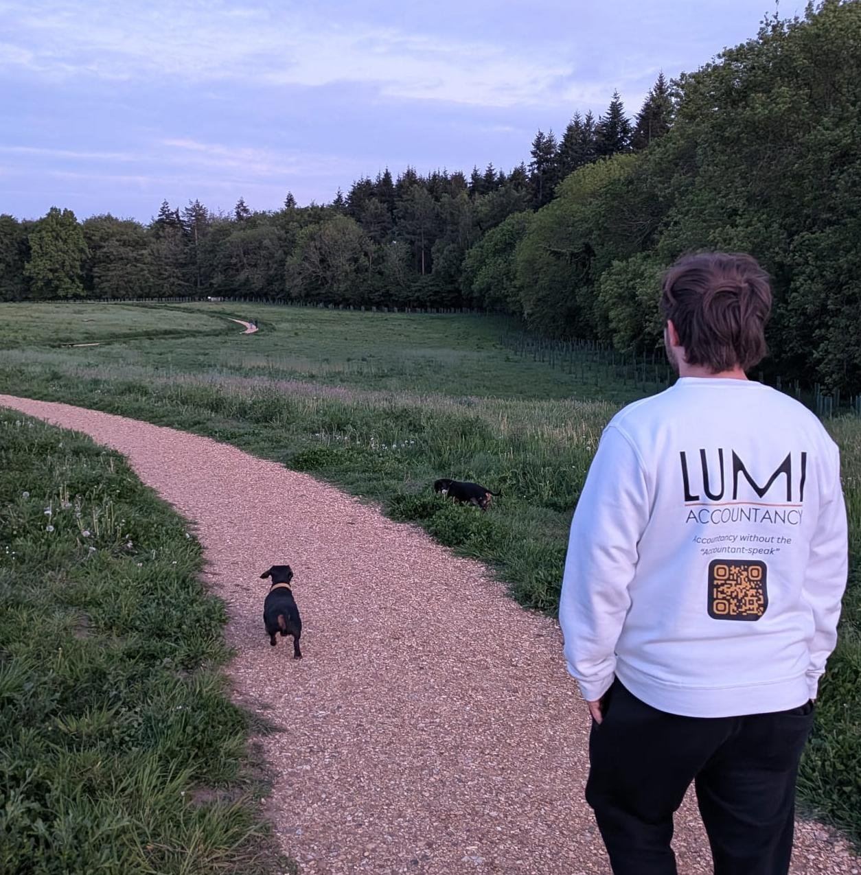 Chris Sullivan, Founder of Lumi Accountancy, walking with his two dachshunds